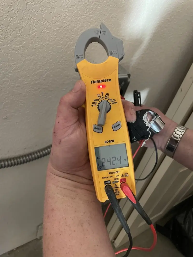 Voltage testing with clamp meter during Outlet Installation in San Diego